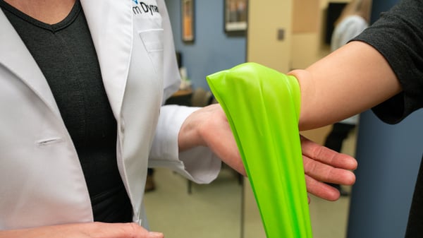 A Clinical Therapy Specialist works on strengthening a patients limb before wearing her prosthesis