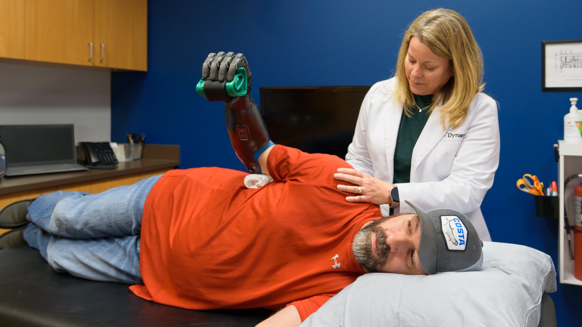 Clinical Therapy Specialist Becky Park, OTR/L, works with a transradial patient on muscle recovery.