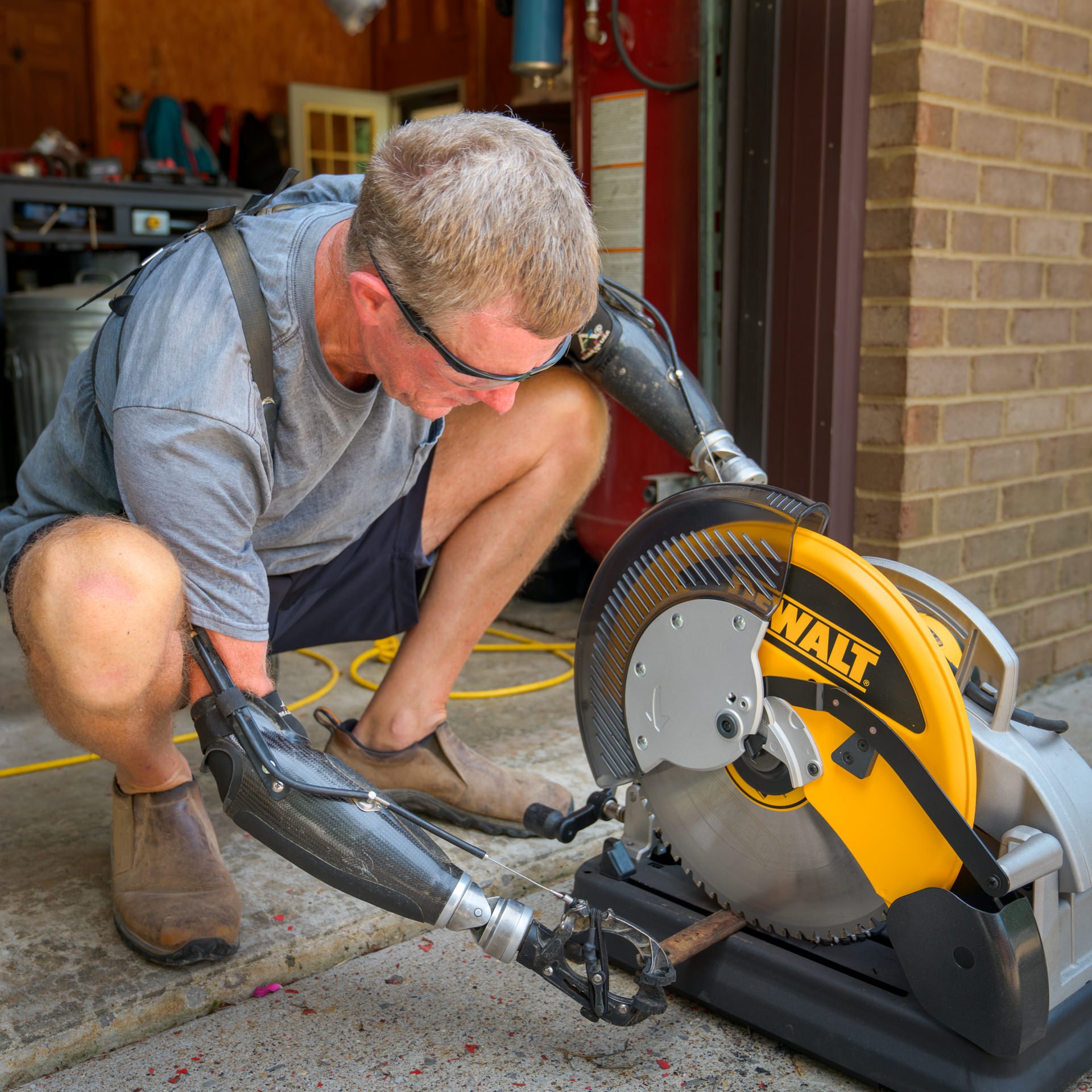 Gerry Kinney, a bilateral transradial patient, uses his body-powered prostheses to get work done.