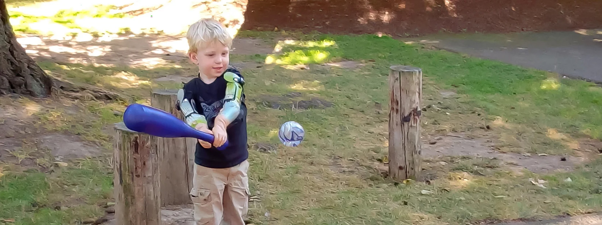 Jameson Davis playing t-ball in the park with his parents