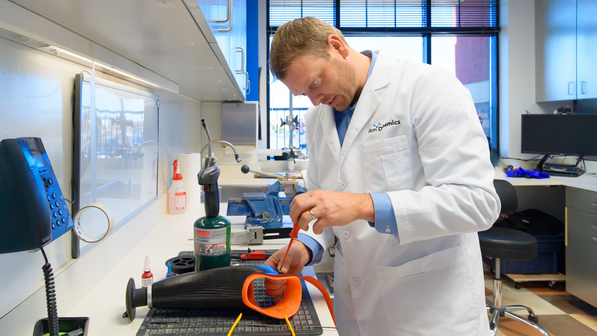 Andy Sabean, CP/LP, makes adjustments to a prosthetic socket in the fabrication lab.